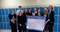 SCQF School Ambassador pupils at Clydebank High School holding an A0 Framework diagram poster