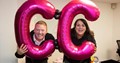 Anna Devitt, CEO of DirectDevitt with colleague holding 2 large pink C balloons
